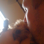 Kristopher Lauchner kissing a dog