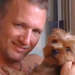 Kristopher Lauchner cuddling with a dog