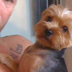 Kristopher Lauchner cuddling with a dog