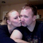 Desiree Capuano kissing Kristopher Lauchner while looking at the camera