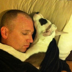 Kristopher Lauchner sleeping with a nasty dog