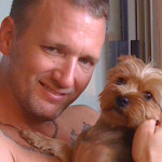 Kristopher Lauchner cuddling with another dog